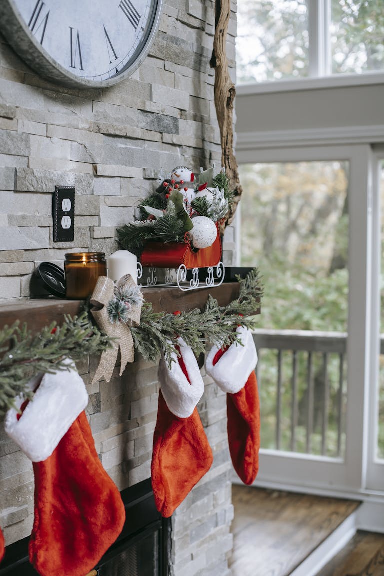 Xmas decorations on brick wall above fireplace