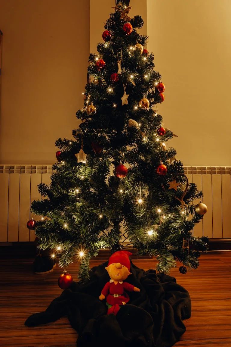 A beautifully decorated Christmas tree with shining lights and vibrant ornaments indoors.